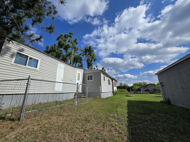 2051 Stutesman Dr, Fairview, MI 48621 - rear view of house featuring a gate