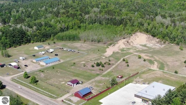birds eye view of property with a view of trees