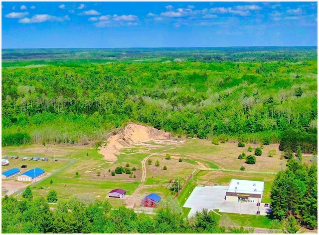 birds eye view of property featuring a view of trees
