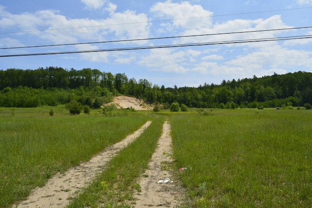 view of road featuring a rural view and a view of trees