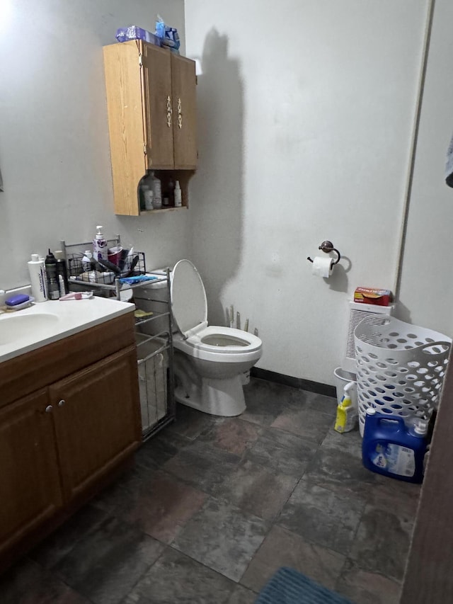 bathroom featuring toilet and vanity