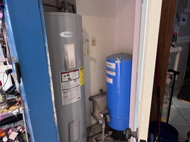 utility room featuring water heater
