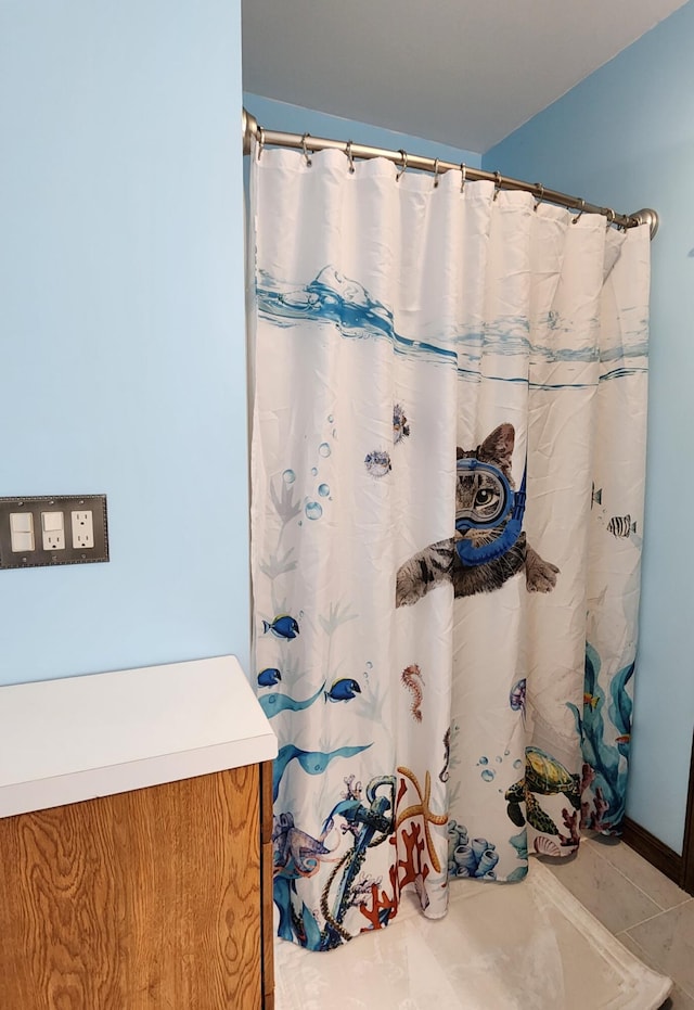 bathroom with tile patterned floors and a shower with curtain