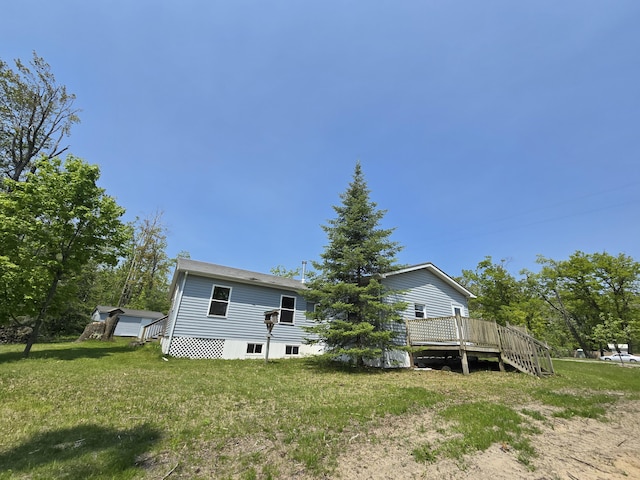 1793 W Kittle Rd, Mio, MI 48647 - back of property featuring a deck and a lawn