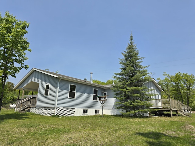 1793 W Kittle Rd, Mio, MI 48647 - rear view of house with a yard and a wooden deck