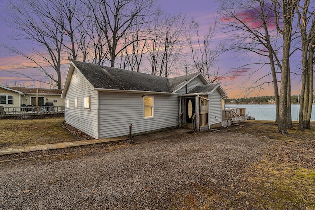 4640 Hiawatha Dr, Cheboygan, MI 49721 - view of front of property featuring a deck with water view and roof with shingles
