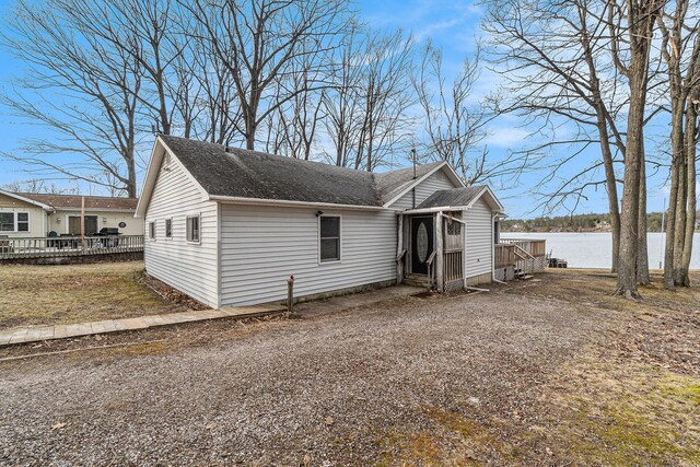 4640 Hiawatha Dr, Cheboygan, MI 49721 - view of front of home featuring a deck with water view and roof with shingles