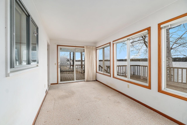 4640 Hiawatha Dr, Cheboygan, MI 49721 - unfurnished sunroom featuring baseboards and carpet