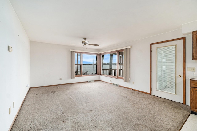 4640 Hiawatha Dr, Cheboygan, MI 49721 - carpeted empty room with baseboards, a ceiling fan, visible vents, and a water view