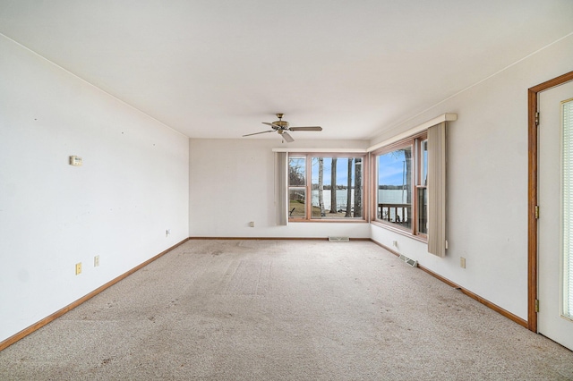 4640 Hiawatha Dr, Cheboygan, MI 49721 - carpeted spare room with visible vents, a ceiling fan, and baseboards