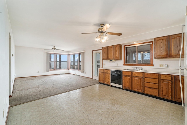 4640 Hiawatha Dr, Cheboygan, MI 49721 - kitchen featuring brown cabinetry, dishwasher, a sink, and a ceiling fan