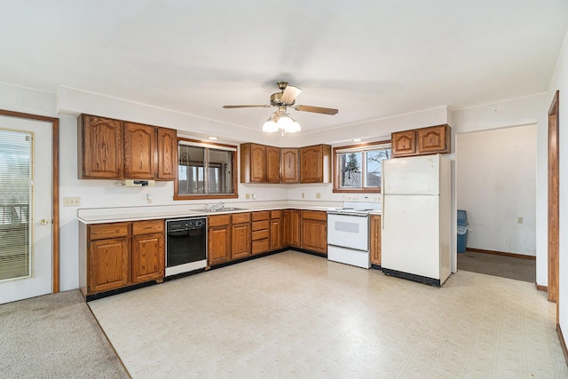 4640 Hiawatha Dr, Cheboygan, MI 49721 - kitchen with brown cabinets, a sink, white appliances, and light countertops
