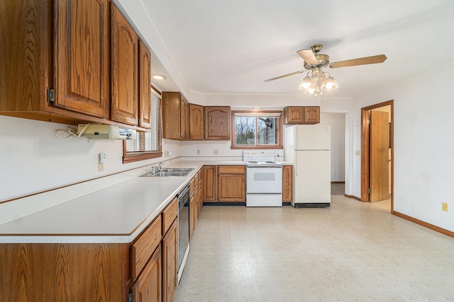 4640 Hiawatha Dr, Cheboygan, MI 49721 - kitchen with light floors, brown cabinetry, a healthy amount of sunlight, and white appliances