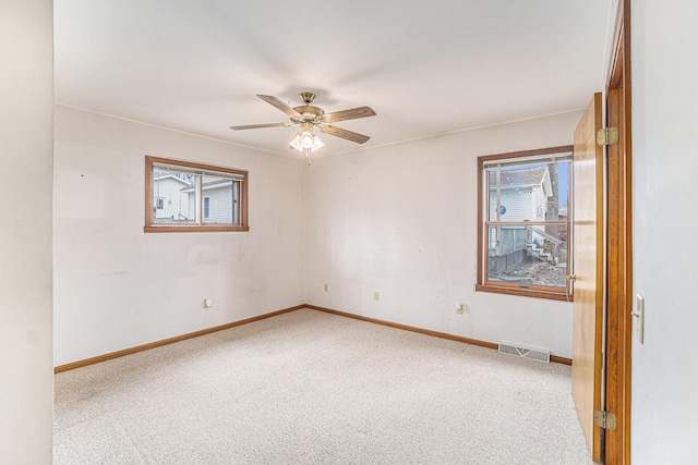 4640 Hiawatha Dr, Cheboygan, MI 49721 - empty room featuring plenty of natural light, a ceiling fan, visible vents, and carpet flooring
