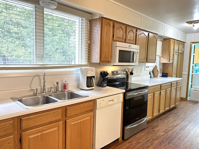 2141 S First Ave, Alpena, MI 49707 - kitchen with dark wood-style flooring, a sink, light countertops, ornamental molding, and white appliances