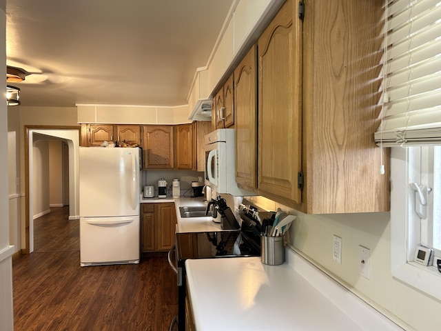 2141 S First Ave, Alpena, MI 49707 - kitchen featuring a sink, white appliances, light countertops, dark wood finished floors, and brown cabinetry