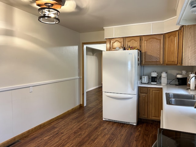 2141 S First Ave, Alpena, MI 49707 - kitchen with visible vents, brown cabinets, a sink, light countertops, and freestanding refrigerator