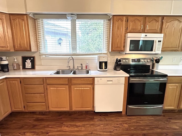 2141 S First Ave, Alpena, MI 49707 - kitchen featuring a sink, light countertops, white appliances, and dark wood finished floors