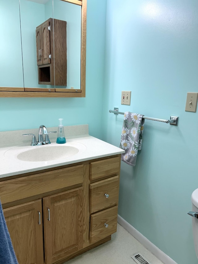2141 S First Ave, Alpena, MI 49707 - half bath featuring toilet, baseboards, and vanity