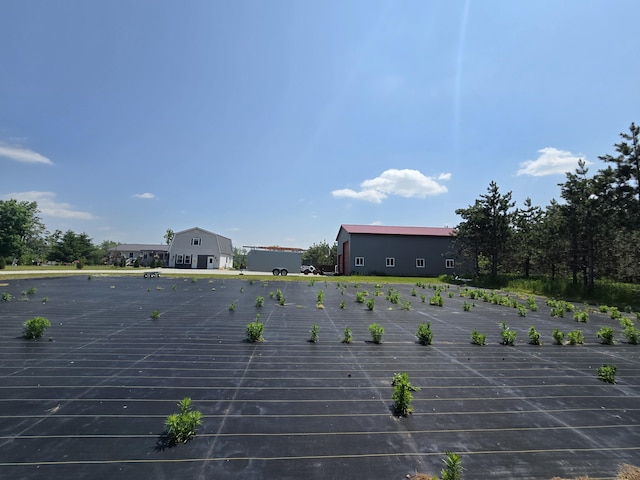 1300 N Perry Creek Rd, Fairview, MI 48621 - exterior view of parking and a rolled roof