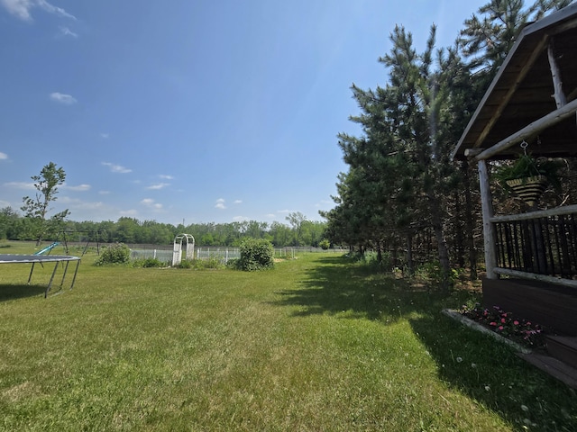1300 N Perry Creek Rd, Fairview, MI 48621 - view of yard with a trampoline
