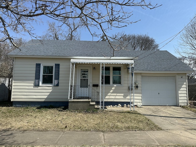 view of front of house with a garage, roof with shingles, and aphalt driveway