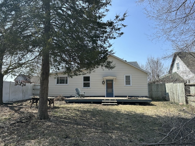 view of front of home with fence and a deck