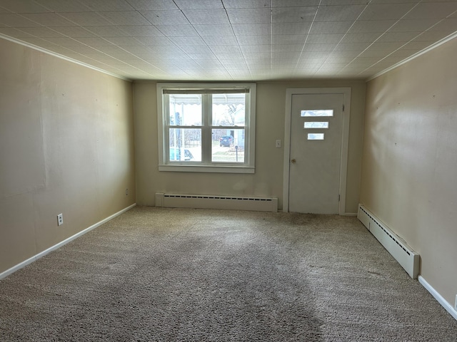 carpeted entrance foyer with ornamental molding and a baseboard radiator