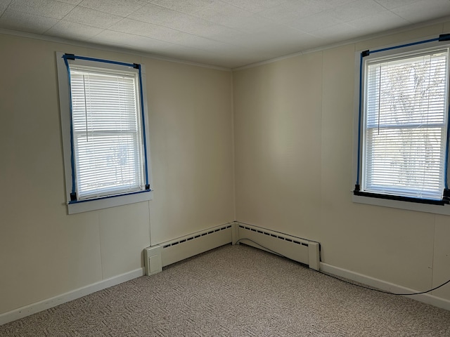 empty room with light carpet, baseboards, and crown molding