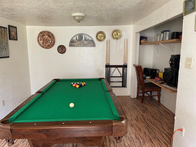 rec room with a textured wall, wood finished floors, a textured ceiling, and billiards