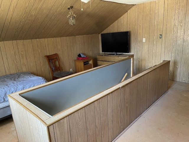 interior space with wooden walls, wooden ceiling, and vaulted ceiling