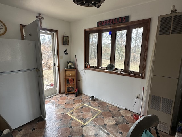 dining space featuring stone finish floor and a heating unit
