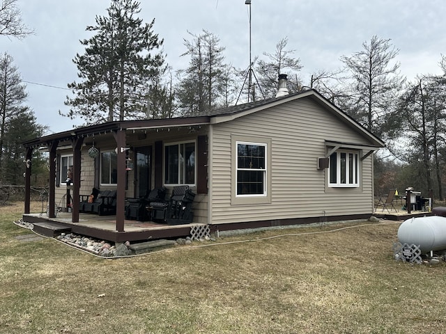 view of home's exterior with a lawn and a wooden deck