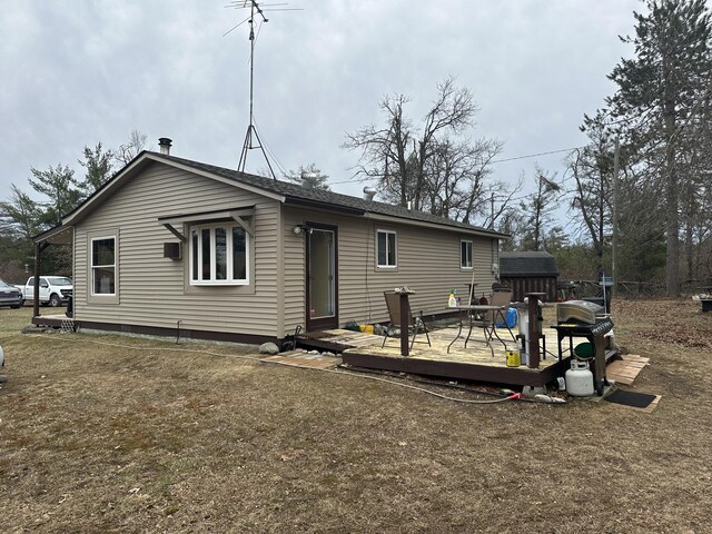 back of house featuring a wooden deck