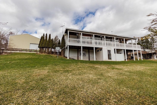 back of house with a wooden deck and a lawn
