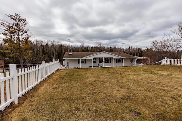 back of house featuring a yard, a fenced backyard, and covered porch