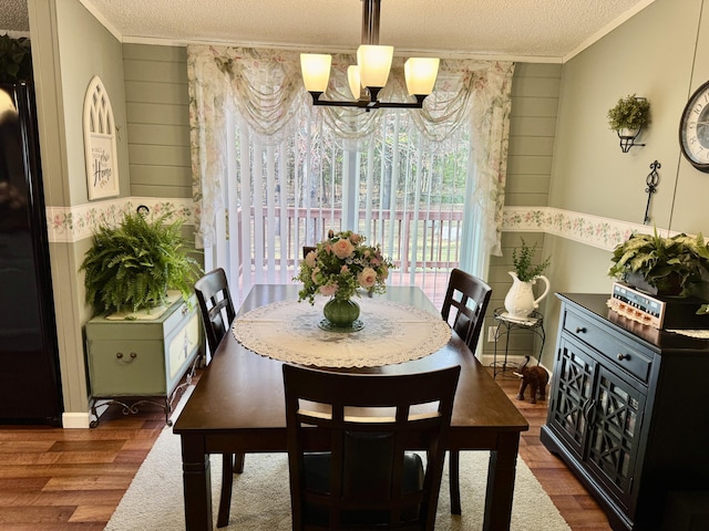 10525 Alpenhof Dr, Grayling, MI 49738 - dining area with a textured ceiling, crown molding, wood finished floors, a chandelier, and wood walls