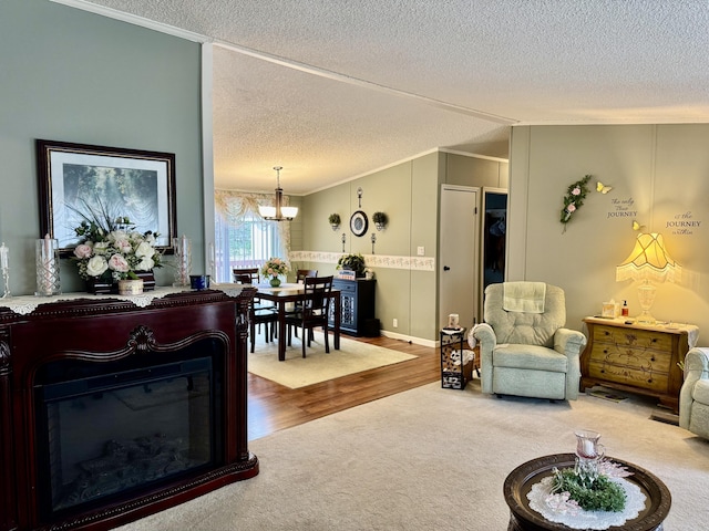 10525 Alpenhof Dr, Grayling, MI 49738 - living area featuring crown molding, a textured ceiling, carpet floors, a chandelier, and vaulted ceiling