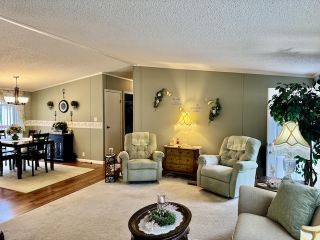 10525 Alpenhof Dr, Grayling, MI 49738 - carpeted living room with a chandelier, a textured ceiling, ornamental molding, wood finished floors, and lofted ceiling