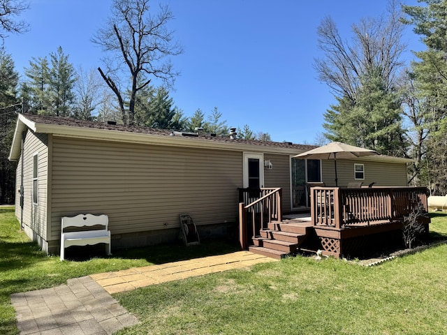 10525 Alpenhof Dr, Grayling, MI 49738 - back of property featuring a wooden deck and a yard