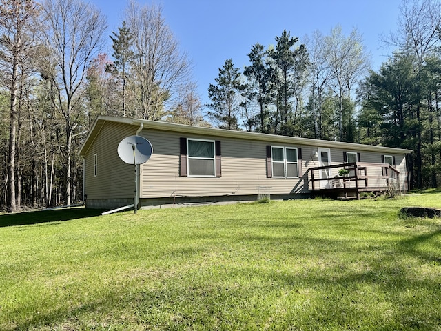 10525 Alpenhof Dr, Grayling, MI 49738 - view of front of house with a deck and a front lawn
