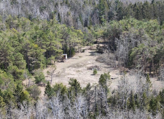 birds eye view of property featuring a wooded view