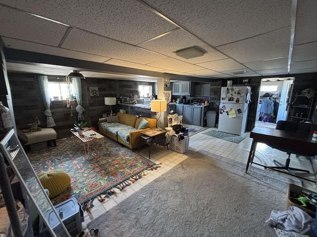 living area with a drop ceiling
