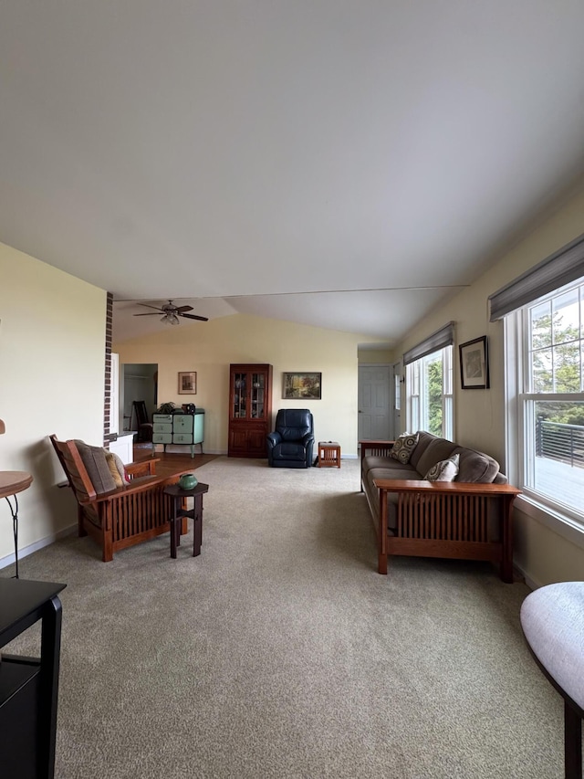 carpeted living area featuring ceiling fan and vaulted ceiling