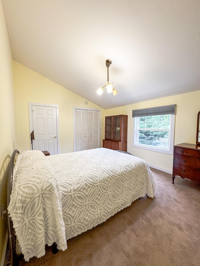 bedroom featuring baseboards, carpet, and vaulted ceiling