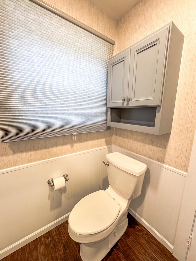 bathroom featuring toilet, baseboards, and wood finished floors