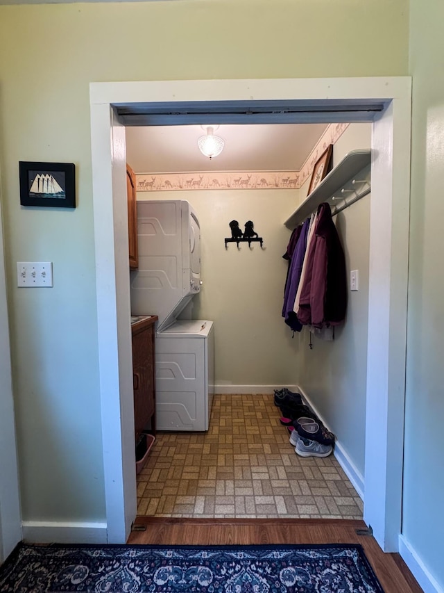1220 N Lake Huron Shore Dr, Harrisville, MI 48740 - washroom with baseboards, laundry area, stacked washer / dryer, and brick floor