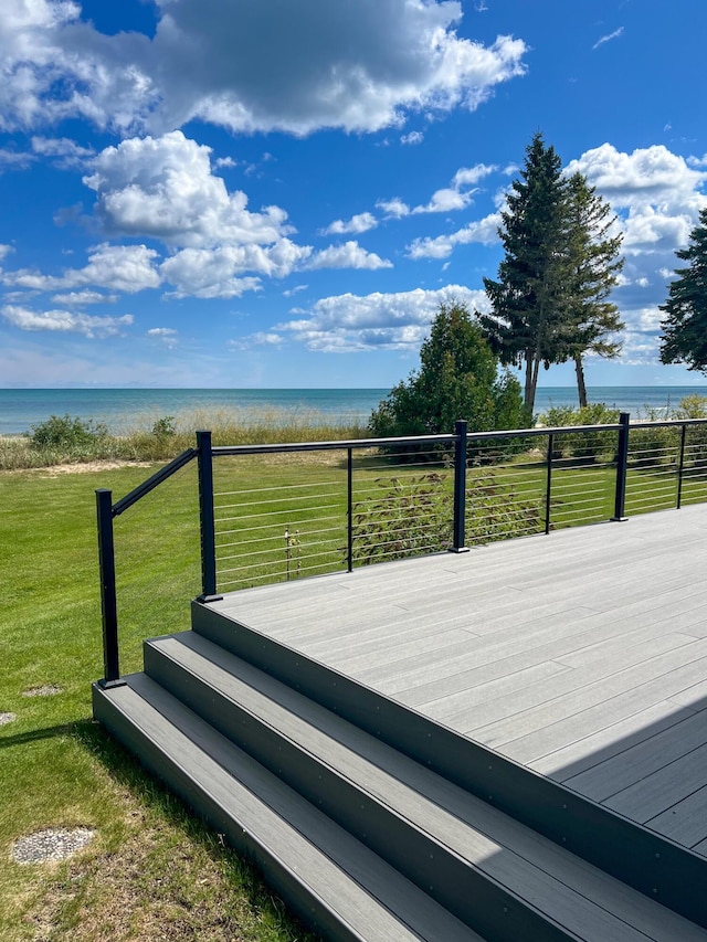 wooden deck featuring a water view and a yard
