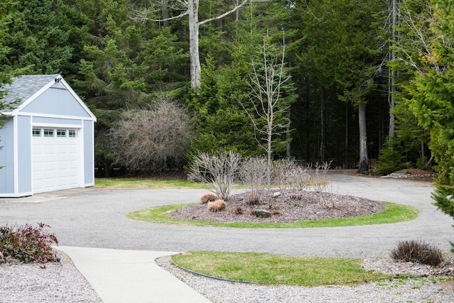 exterior space featuring a view of trees and driveway