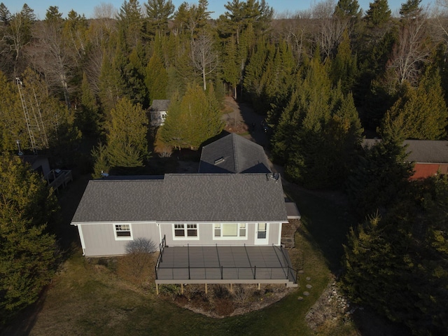 birds eye view of property with a wooded view